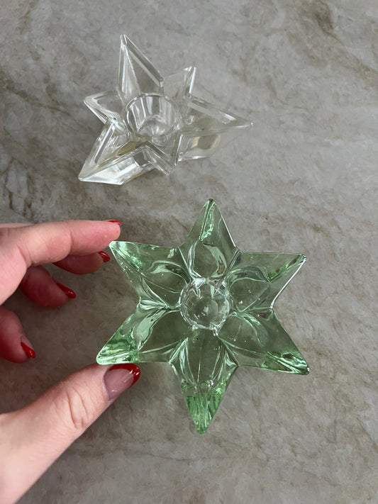 Två ljushållare i form av stjärnor i glas